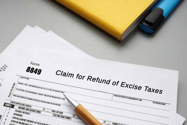 IRS Form 8849 for claim of refund of excise taxes with pen and notebook